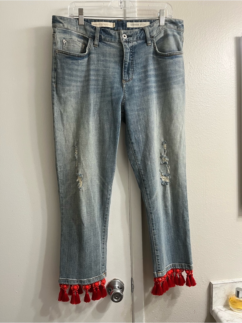 Pilcro Light Blue Distressed Ankle Jeans with Red Tassel Hem